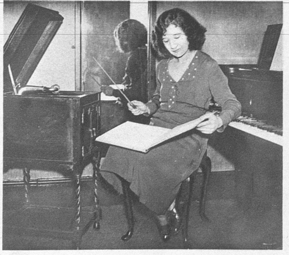 Avril sat at a piano conducting to sheet music